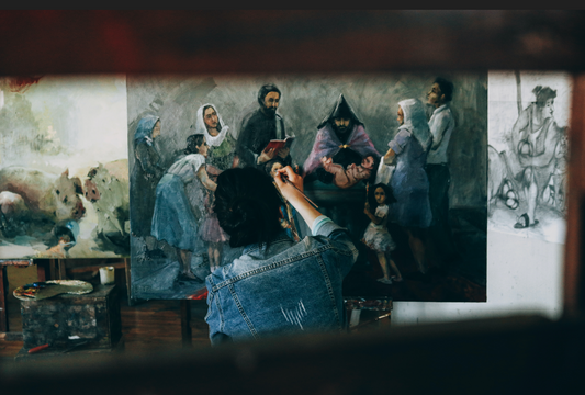 an artist works on painting during her time staying in artist residency