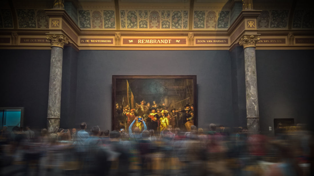 people passing by viewing an exhibited painting that has been appraised at a high value