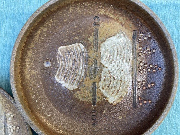 Double Slit Experiment, 2024, woodfired ceramic, 1.5 x 9 x 9 in. / 3.81 x 22.86 x 22.86 cm.