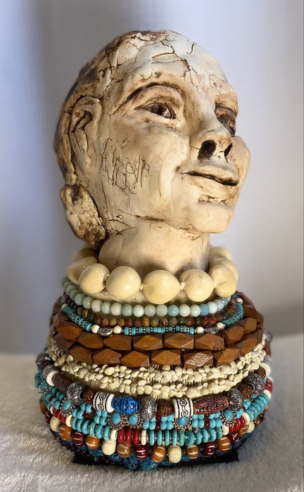 Beaded Woman, 2022, ceramic and mixed media, 13 x 8 x 8 in. / 33.02 x 20.32 x 20.32 cm.