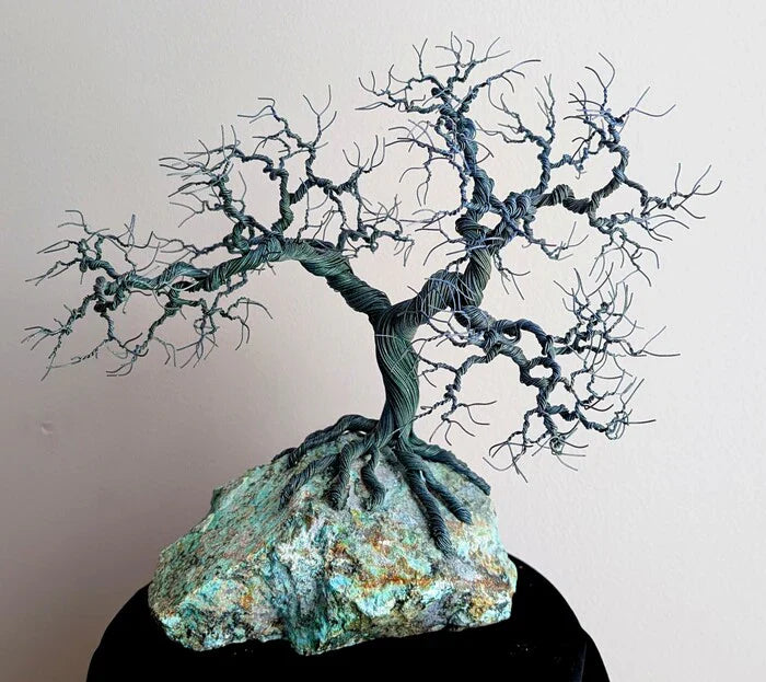 Tree Envy, Ronald Headings, 2026, wire tree sculpture on stone, 9 x 9 x 5 in. / 22.86 x 22.86 x 12.7 cm.