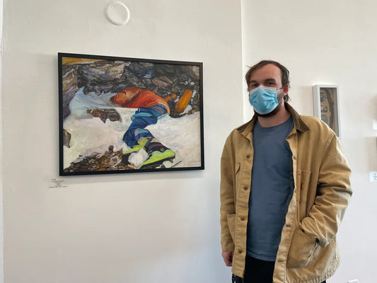 Gavin Coates standing with his painting "Green Boots" at Art on the Terrace Gallery in Staten Island, NY c. 2021