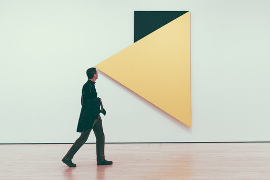 art enthusiast views fine art exhibition in a museum