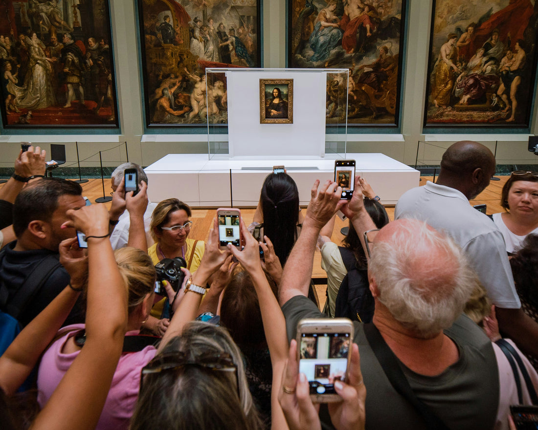 mona lisa being photographed by museum visitors