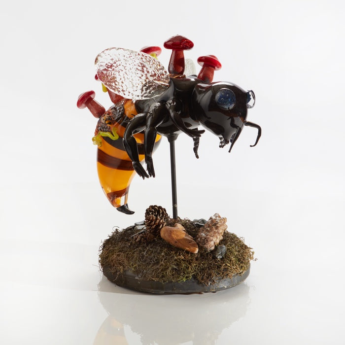 Varroa Destructor, 2023, hot-sculpted glass, preserved moss, found plant life, 16 x 14 x 11 in. / 40.64 x 35.56 x 27.94 cm.