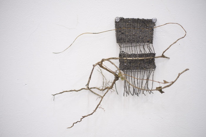 Weaving 2, 2025, yarn and vines, 15 x 5 in. / 38.1 x 12.7 cm.