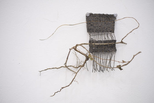 Weaving 2, 2025, yarn and vines, 15 x 5 in. / 38.1 x 12.7 cm.
