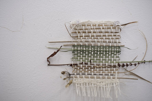 Weaving 3, 2025, yarn and found grass, 15 x 3 in. / 38.1 x 7.62 cm.
