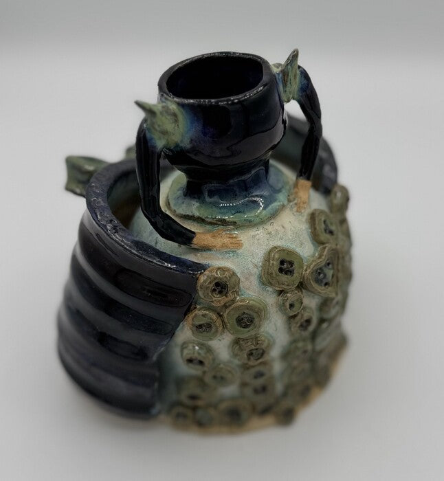 Buttoned-Up, 2025, ceramics, 10 x 6 x 5 in. / 25.4 x 15.24 x 12.7 cm.