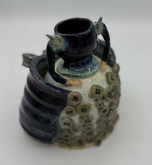 Buttoned-Up, 2025, ceramics, 10 x 6 x 5 in. / 25.4 x 15.24 x 12.7 cm.
