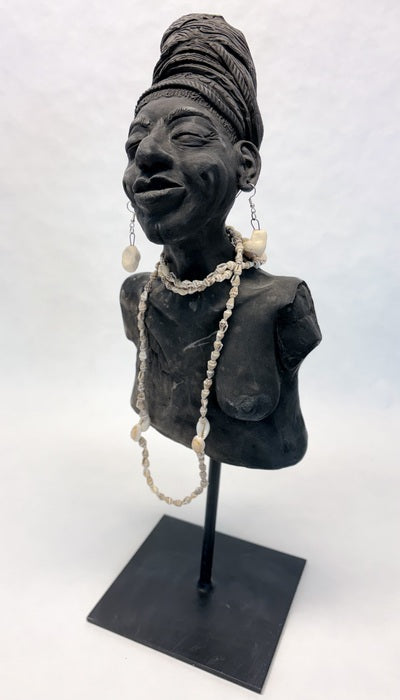 Breast Cancer Triumph, 2025, clay sculpture, 8 x 5 x 5 in. / 20.32 x 12.7 x 12.7 cm.