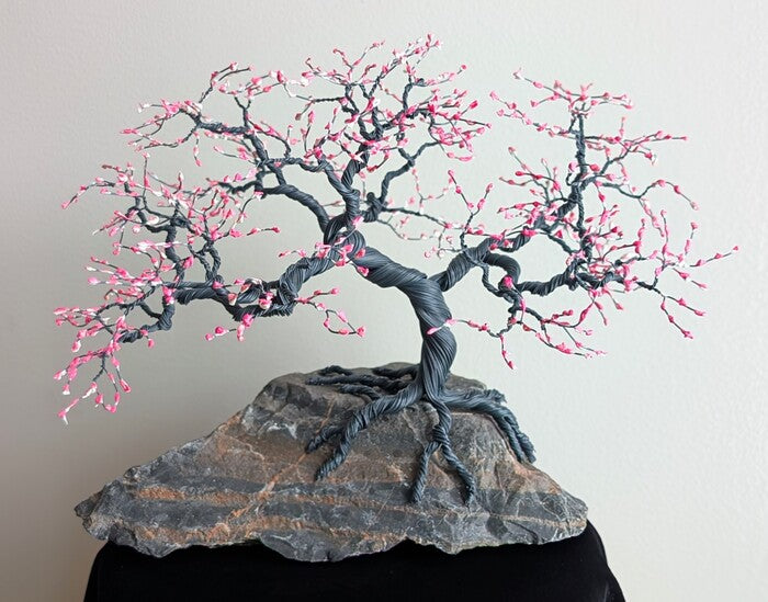 Pink Dogwood, 2026, wire tree sculpture on stone, 9 x 9 x 5 in. / 22.86 x 22.86 x 12.7 cm.