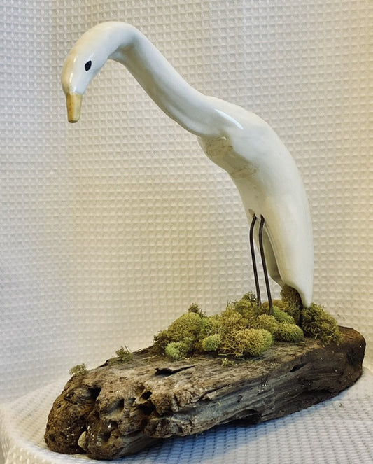 Egret, 2019, clay on wood moss, 14 x 15 x 8 in. / 35.56 x 38.1 x 20.32 cm.