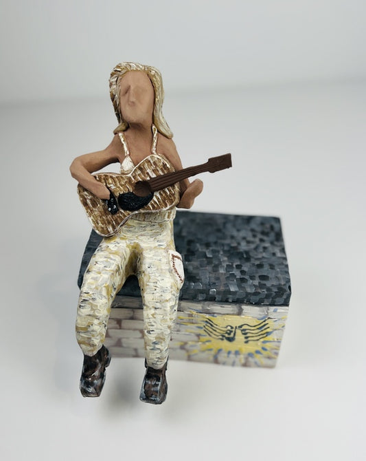 Woman Who Rocks Guitar, 2023, ceramic, 7.75 x 5.5 in. / 13.97 x 19.68 cm.