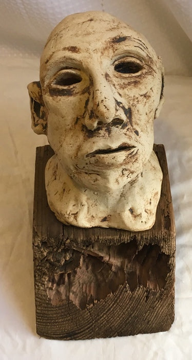 Trapped Chilean Miner Looking to the Light, 2012, clay and wood, 12 x 8 x 8 in. / 30.48 x 20.32 x 20.32 cm.